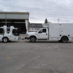 Picture of tracker in front the truck